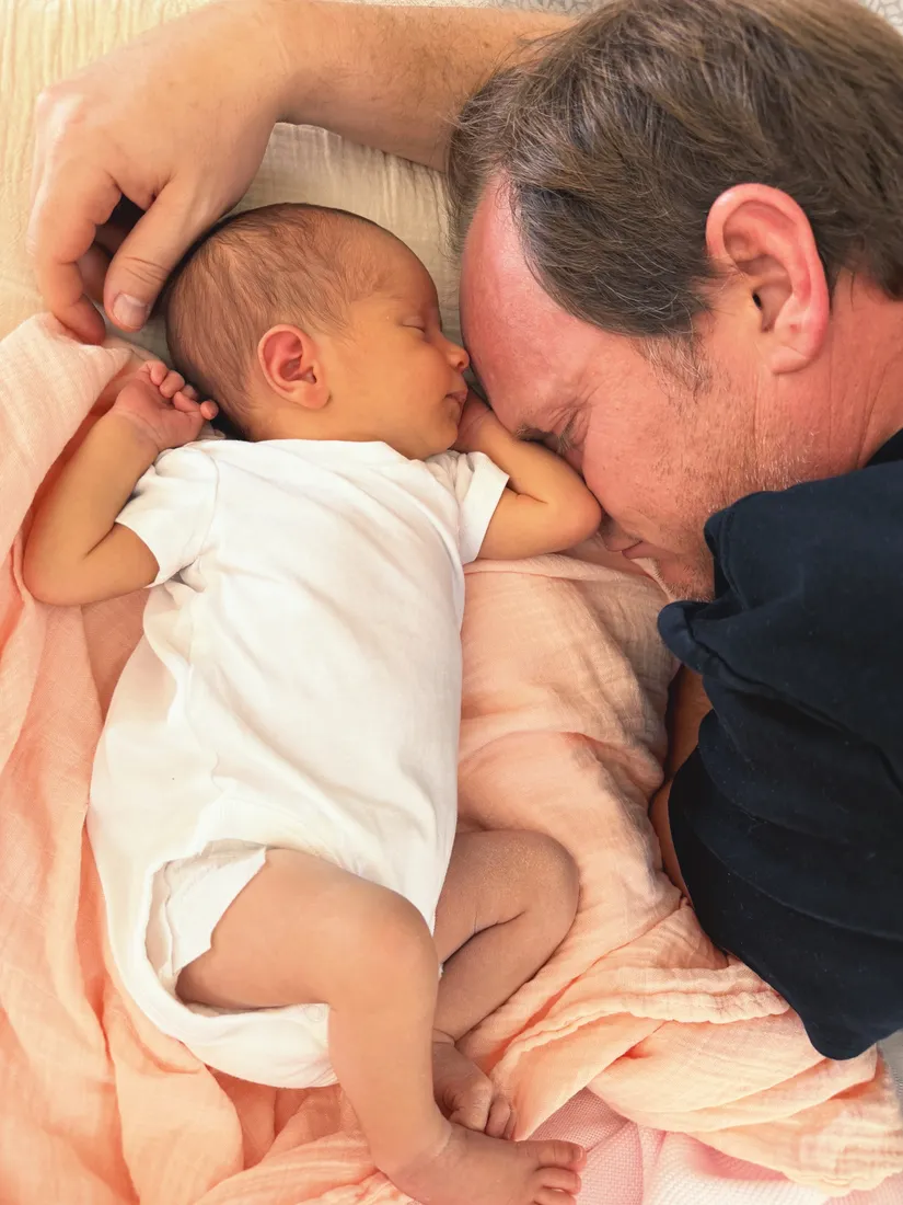 Robert nose to nose with newborn Helena, both resting